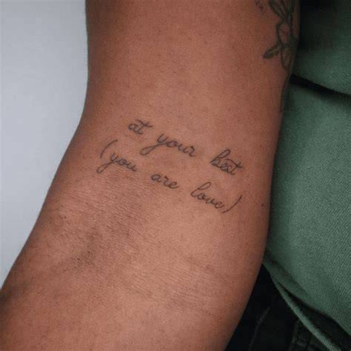 an arm tattoo reads mob or money over bitches