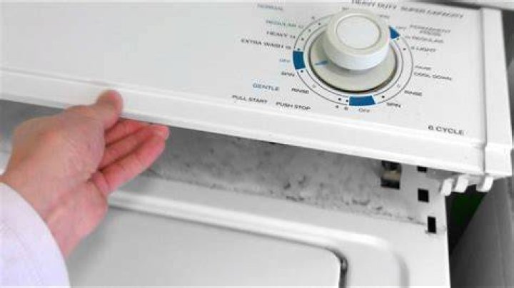 How do you remove the front panel of a Kenmore stackable washer?