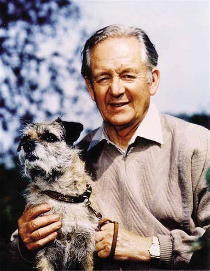 James Herriot holding a cage containing a ferrett