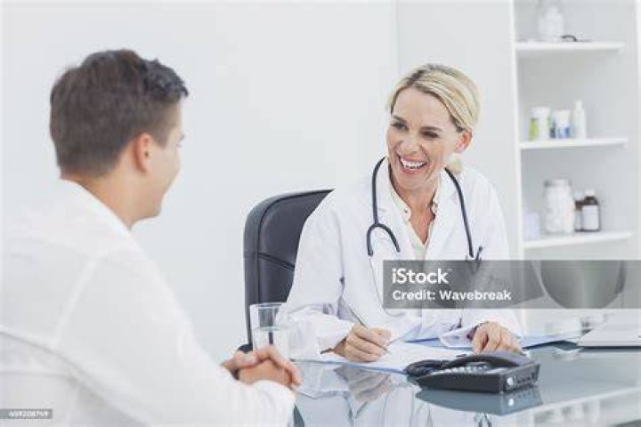 The Doctor laughing at a victim on the hook in Dead by Daylight