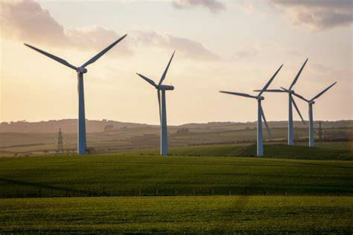 Wind turbines are seen in front of a coal power plant of German utility RWE Power near the western town of Neurath February 28, 2014. Photo by REUTERS/Ina Fassbender